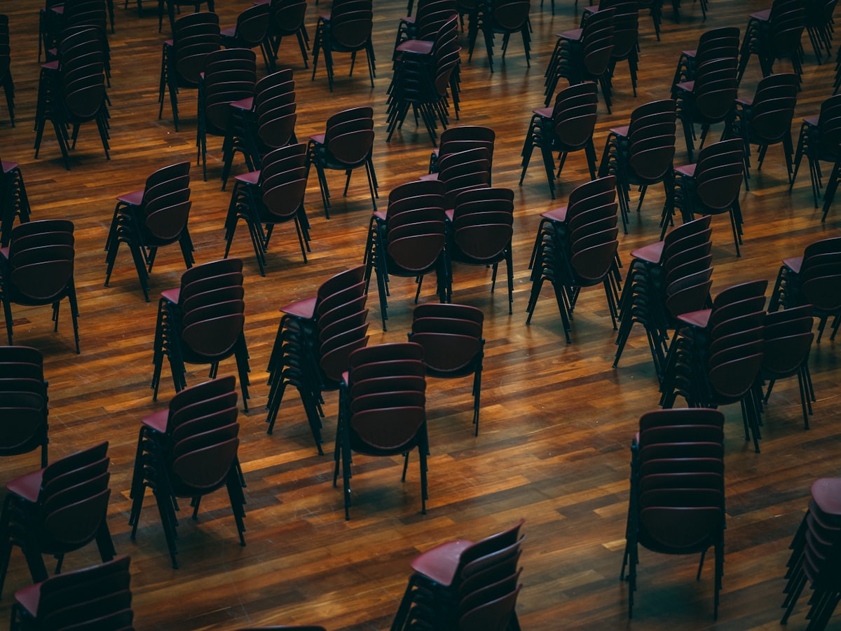 Rows of empty banquet chairs set for a training session.