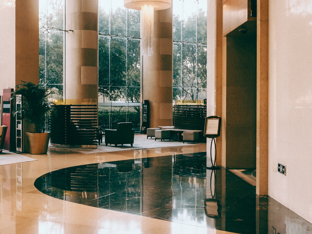 Empty hotel foyer with a long registration desk awaiting attendees.