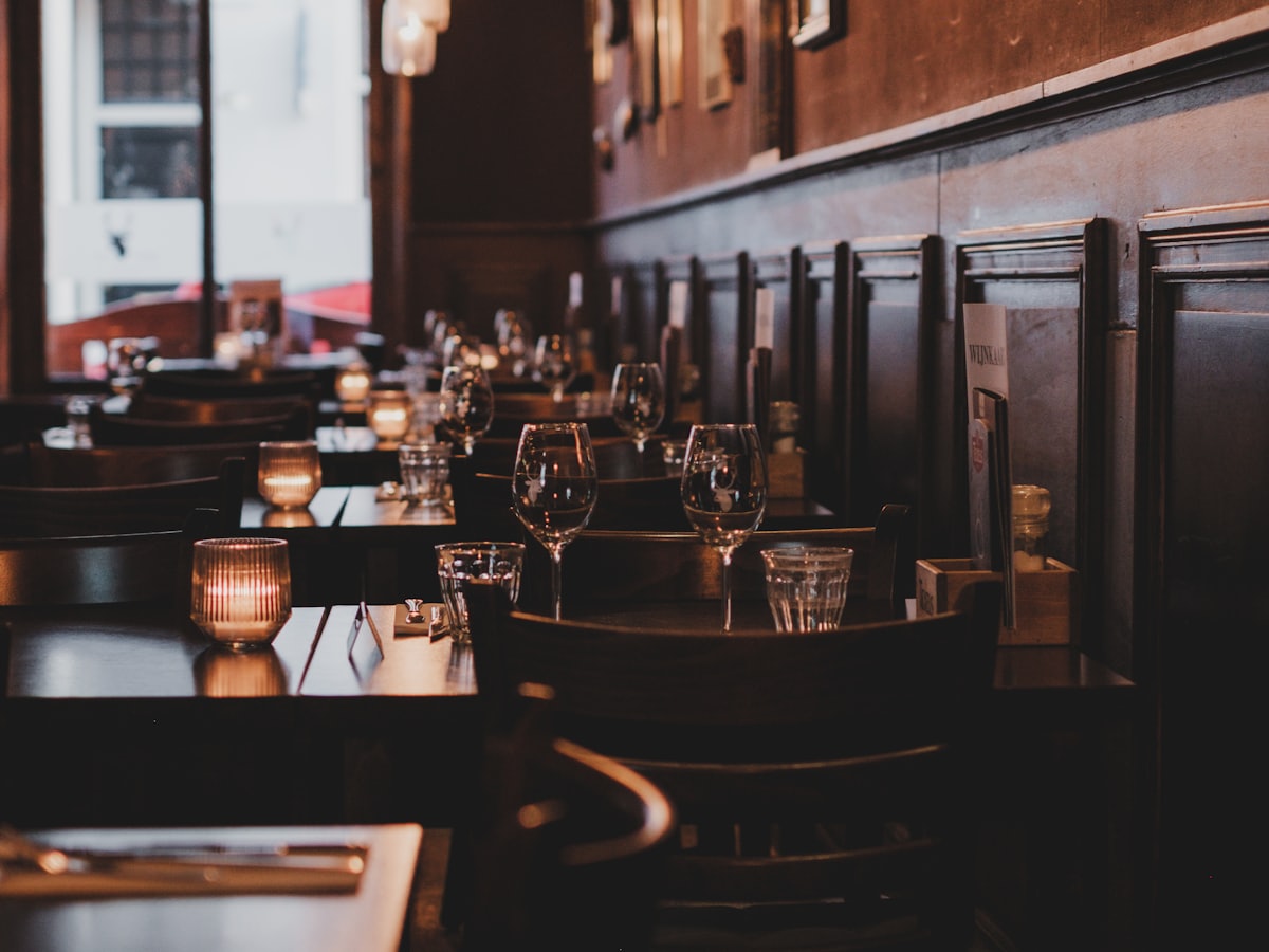 Detail of a set dinner table in an empty restaurant.